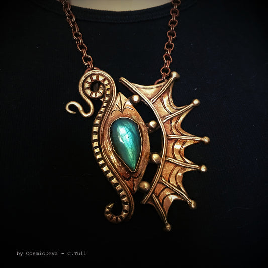 The Dragon is often seen as the guardian of a treasure. The treasure symbolizes you. This beautifully hand sculptured, carved, forged and kiln fired bronze pendant necklace symbolizes the Eye of a Dragon featuring a magical mystical shimmering labradorite gemstone. The reverse of the pendant is signed by the artist and carries the CosmicDeva brand hallmark.- CosmicDeva