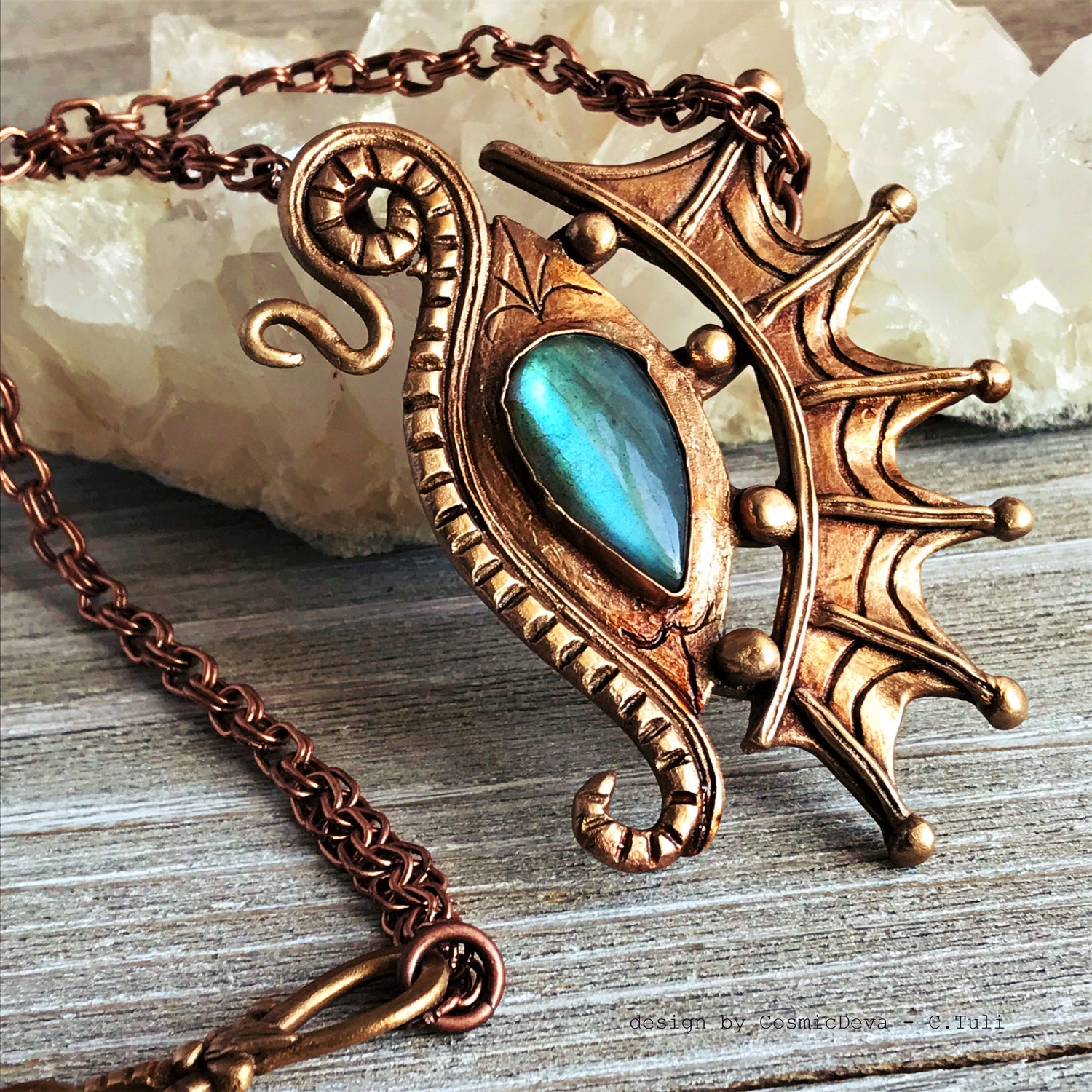 The Dragon is often seen as the guardian of a treasure. The treasure symbolizes you. This beautifully hand sculptured, carved, forged and kiln fired bronze pendant necklace symbolizes the Eye of a Dragon featuring a magical mystical shimmering labradorite gemstone. The reverse of the pendant is signed by the artist and carries the CosmicDeva brand hallmark.- CosmicDeva