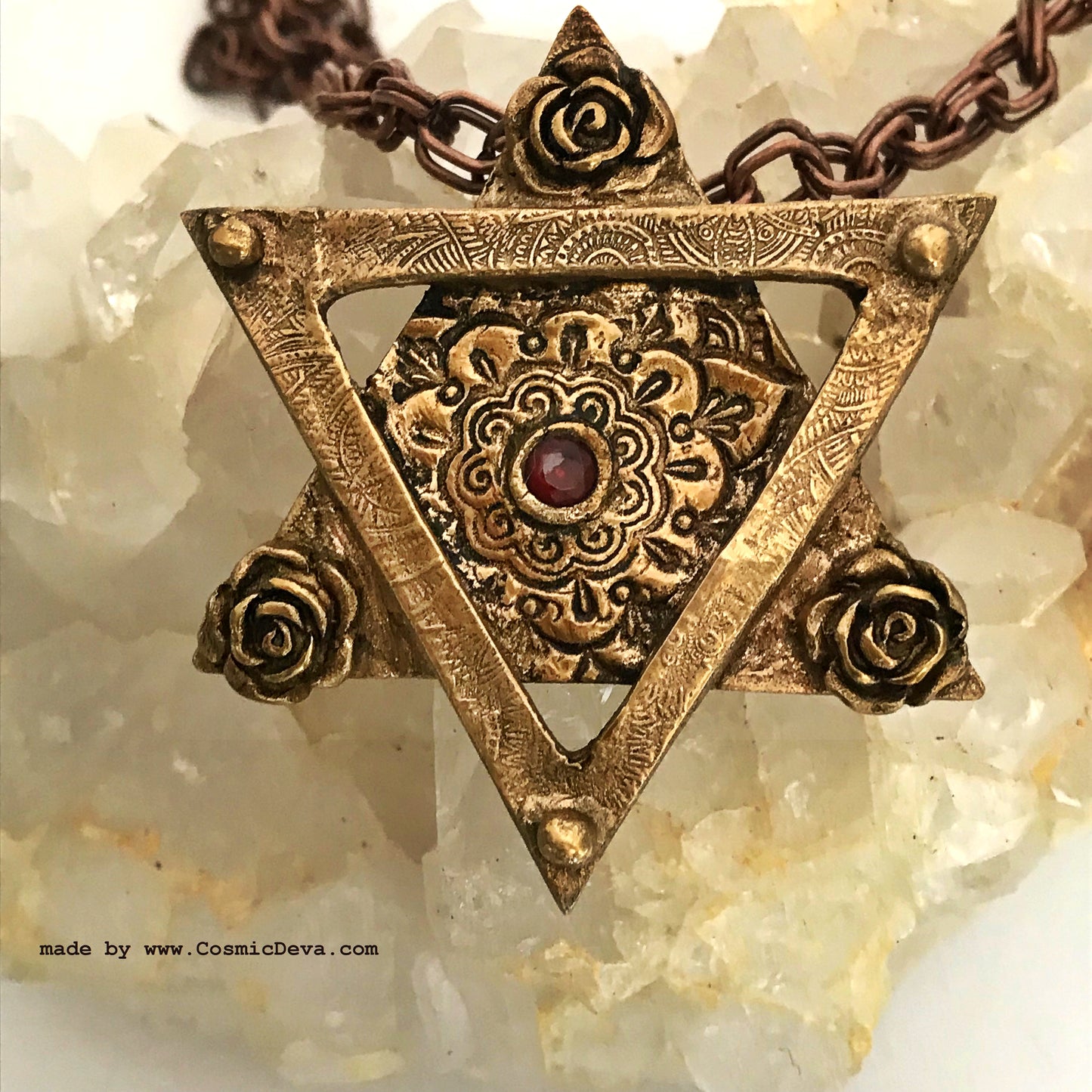 Be the star of any Bat Mitzvah with this exquisite Star of David Necklace! Crafted with an original hand-sculpted bronze design and featuring a red lab-grown garnet hessonite stone, this unique Magen David pendant will add a touch of elegance and tradition to your special day.- CosmicDeva
