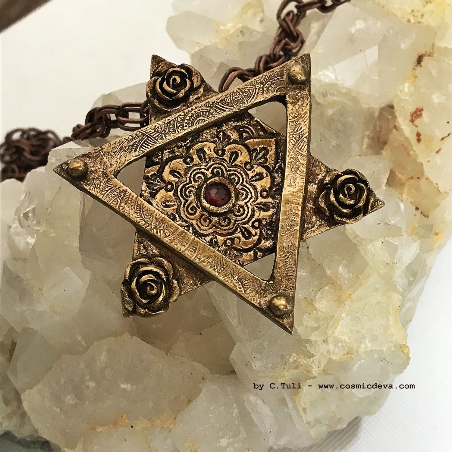 Be the star of any Bat Mitzvah with this exquisite Star of David Necklace! Crafted with an original hand-sculpted bronze design and featuring a red lab-grown garnet hessonite stone, this unique Magen David pendant will add a touch of elegance and tradition to your special day. - CosmicDeva
