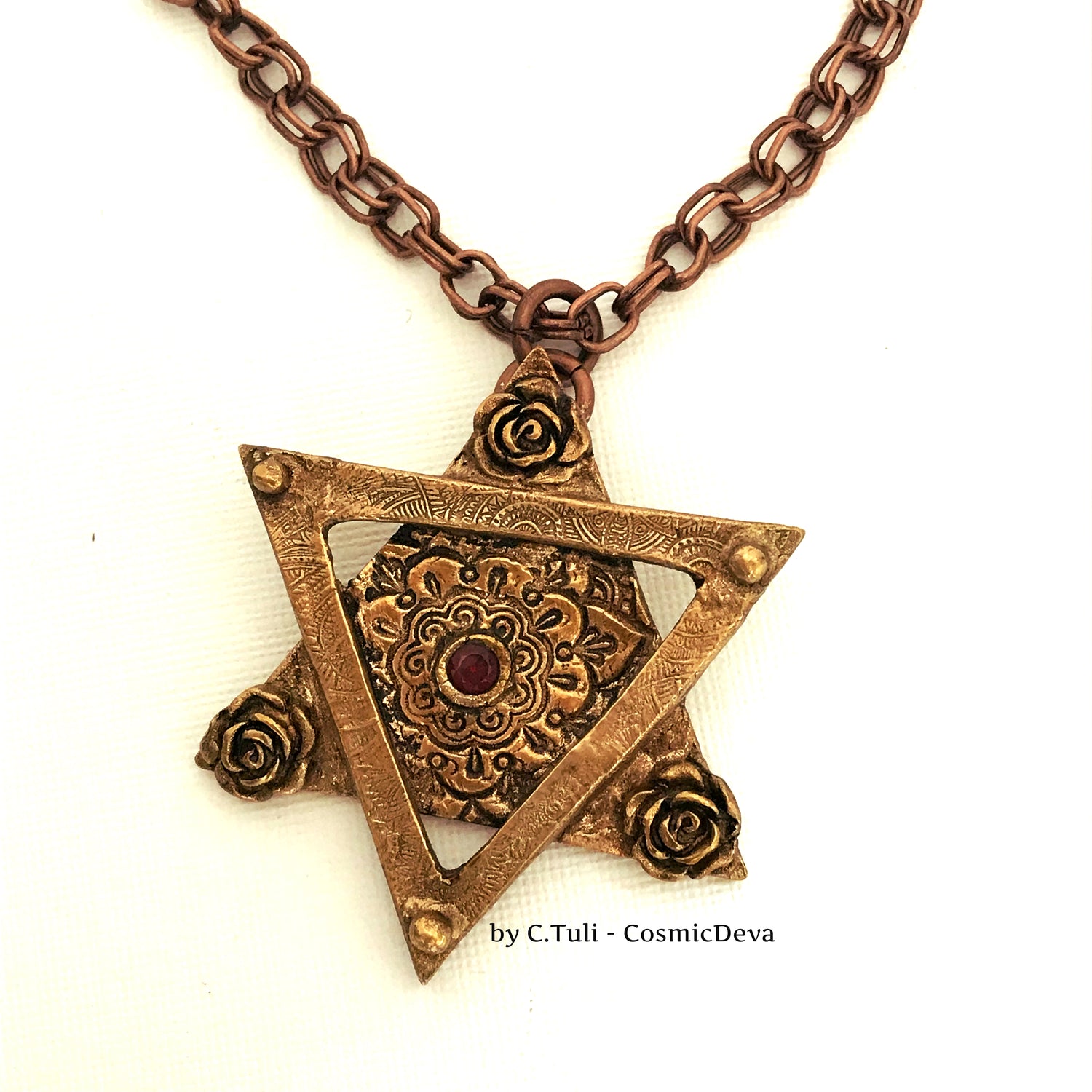 Be the star of any Bat Mitzvah with this exquisite Star of David Necklace! Crafted with an original hand-sculpted bronze design and featuring a red lab-grown garnet hessonite stone, this unique Magen David pendant will add a touch of elegance and tradition to your special day.- CosmicDeva