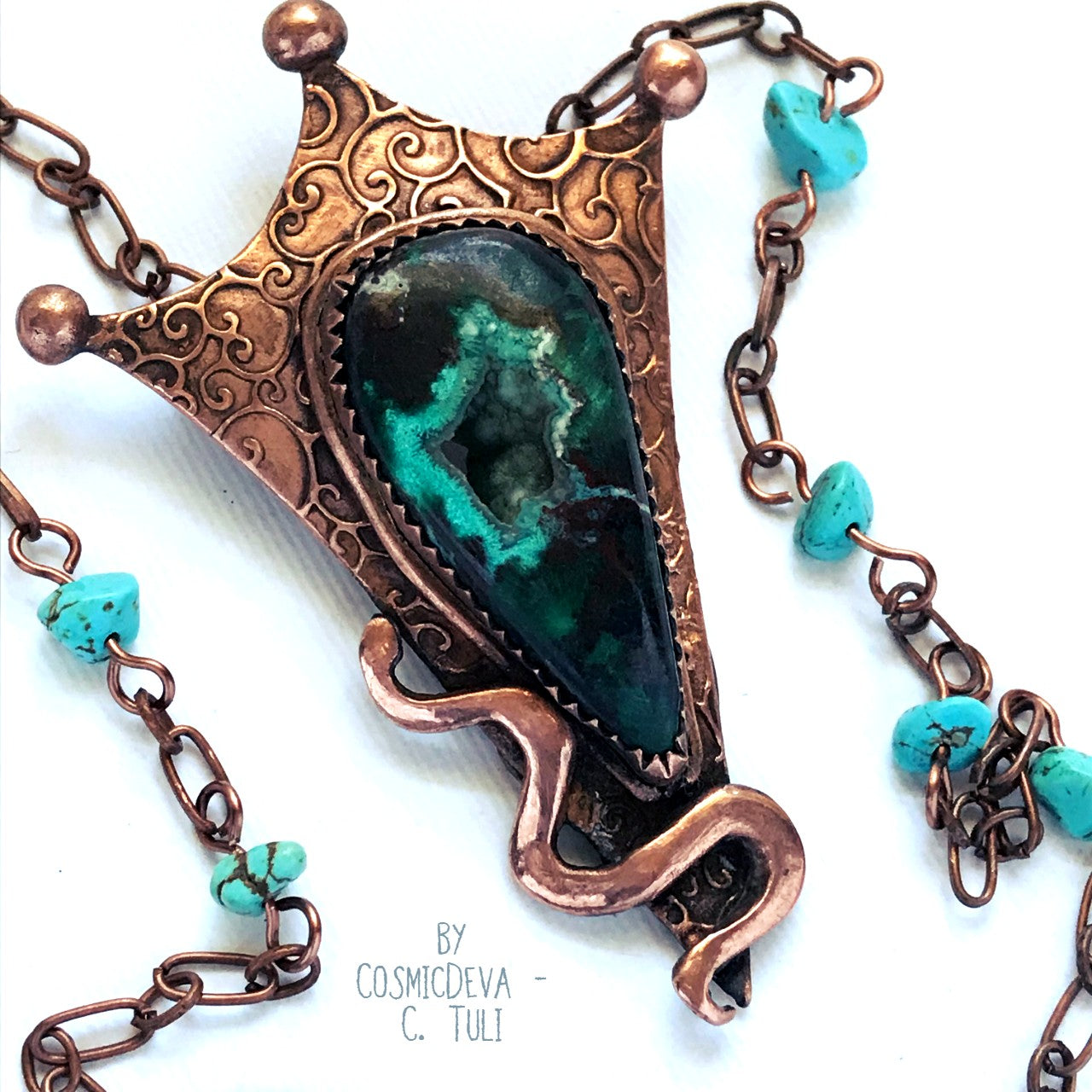 Botryoidal Chrysocolla Copper Snake Pendant Necklace This unique Chrysocolla with Malachite and traces of cuprite gemstone is nestled amidst a complete hand sculptured triangle pendant with a little snake winding up in rich and warm glowing copper and has beautiful swirl texture. This rustic copper statement necklace suspends from a copper chain with natural turquoise beads. The copper jewelry piece was oxidized for a deep warm finish.- CosmicDeva