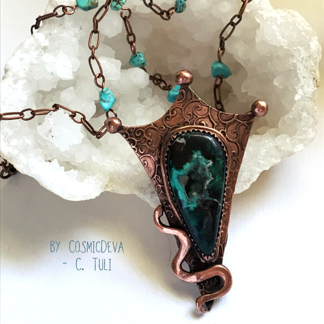 Botryoidal Chrysocolla Copper Snake Pendant Necklace This unique Chrysocolla with Malachite and traces of cuprite gemstone is nestled amidst a complete hand sculptured triangle pendant with a little snake winding up in rich and warm glowing copper and has beautiful swirl texture. This rustic copper statement necklace suspends from a copper chain with natural turquoise beads. The copper jewelry piece was oxidized for a deep warm finish.- CosmicDeva