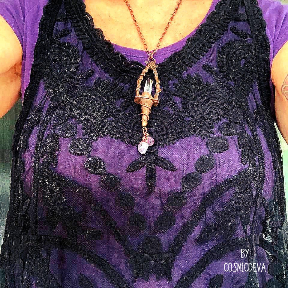 Weave a little magic into your wardrobe with this stunning magickal copper lantern necklace. Featuring a hand-sculpted, warm-glowing copper pendulum adorned with a super-clear Vera Cruz amethyst crystal point, plus two fluoride gemstones, it's a captivating conversation piece that will ignite your imagination. Suspended from an adjustable 21" copper chain, the oxidized finish and wax seal create a rich, deep warmth that will have you looking spell-bindingly beautiful.