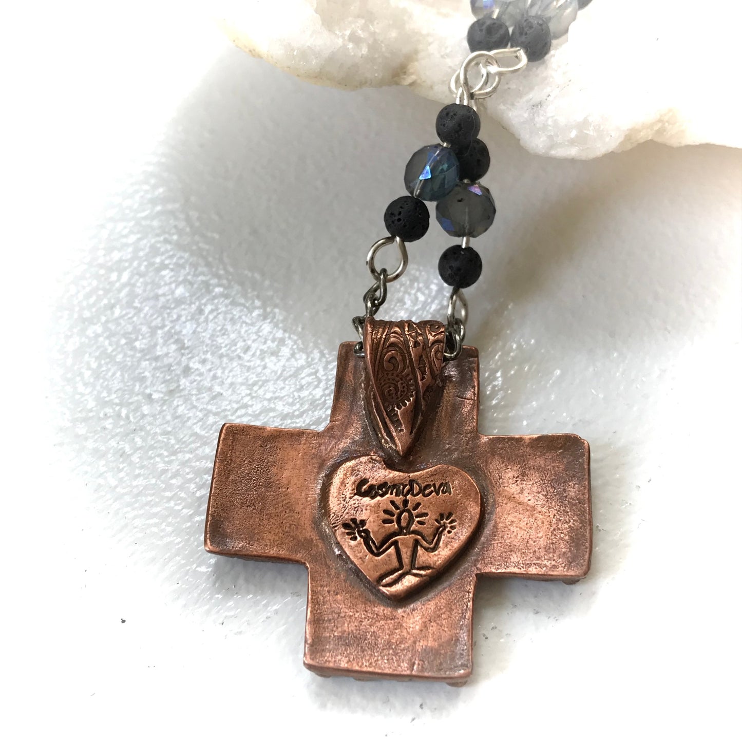 Copper Cross Rosary Necklace, Boho Faith Jewelry. A beautiful completely handmade and kiln fired western cross pendant made of solid pure copper dangles from a rosary necklace with gorgeous petite blue Czech beads and black lava beads. The handmade rosary chain is made of .925 sterling silver plated wire with sparkling blue faceted Czech glass beads and small black volcanic lava stone beads. A pretty little heart is stamped with the artist’s logo on the backside adding a lovely detail. - CosmicDeva