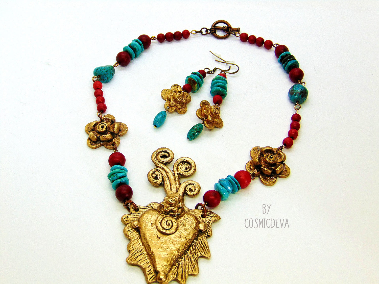 Gold Bronze Milagro Heart  Sacred Heart Necklace Set. Stunning bold one of a kind hand sculptured solid golden bronze milagro heart and flower necklace set with natural turquoise, red howlite gemstone beads was kiln fired in my studio with pure Bronze from Bronze Metal Clay.   This necklace comes with a matching pair of ear rings- CosmicDeva