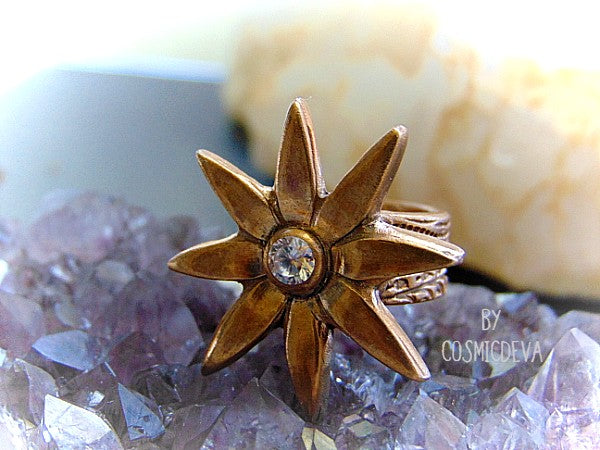 Add some sparkle to your life with this beautiful Flower Cocktail Ring! Handcrafted with a solid gold bronze setting and a dazzling cubic zirconia gemstone, this statement ring will make your look shine! Upgrade your wardrobe - and your confidence - today!   - CosmicDeva