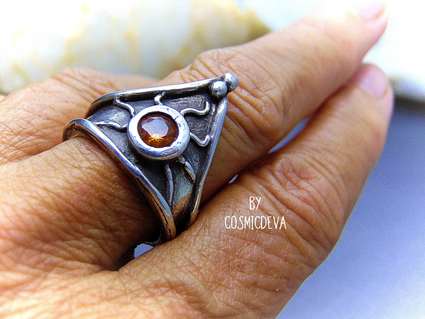 Be the knight in shining armor with this beautiful sterling silver ring! Handcrafted with a medieval triangle shield design, this classic piece is set with a 5mm round citrine stone and oxidized for a vintage antique look. The decorative hand sculptured triangle shield makes the perfect centerpiece, adding an antique charm to your everyday look.- CosmicDeva