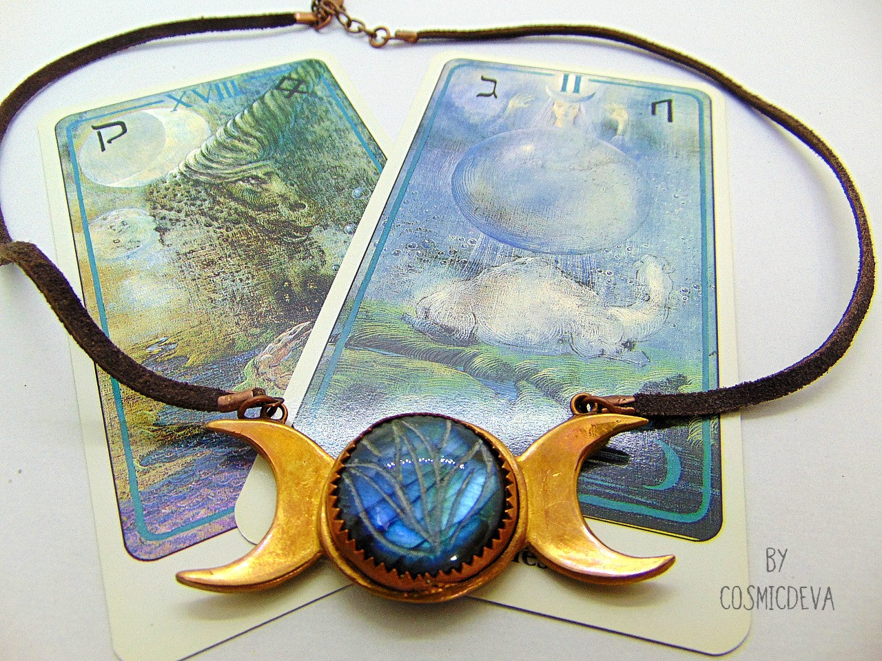 Wear the Triple Moon Goddess necklace as a powerful reminder of your connection to the divine feminine. Crafted with pure gold bronze and featuring a stunning blue labradorite gemstone with a floral engravement- CosmicDeva