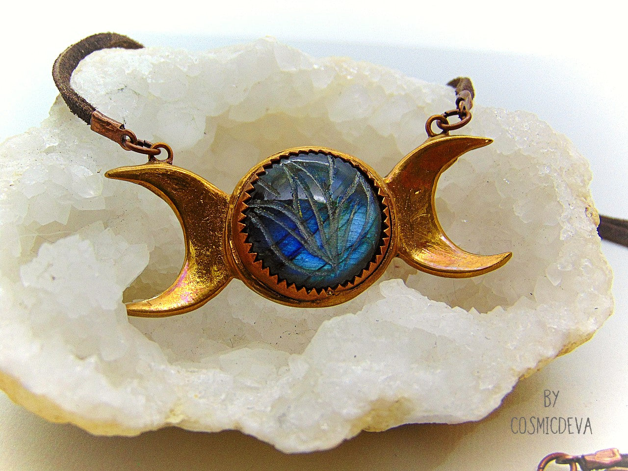 Wear the Triple Moon Goddess necklace as a powerful reminder of your connection to the divine feminine. Crafted with pure gold bronze and featuring a stunning blue labradorite gemstone with a floral engravement- CosmicDeva