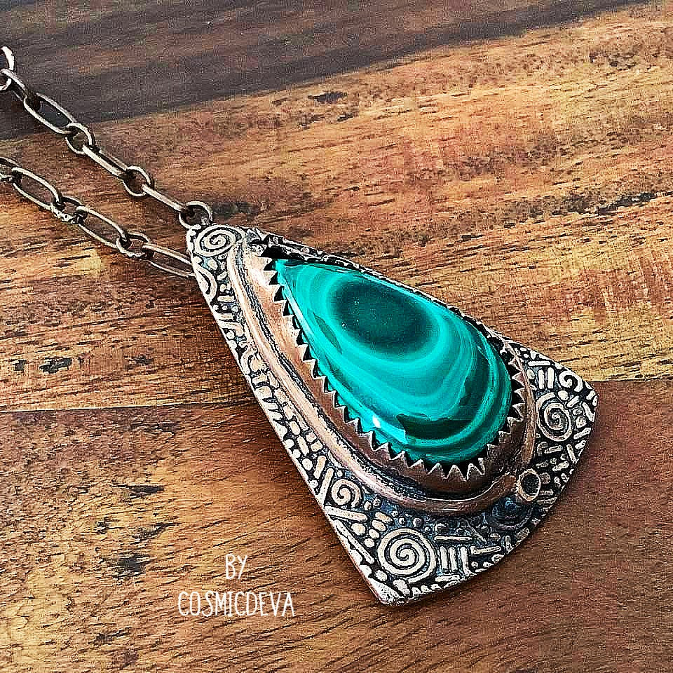 Wrap yourself in the irresistible beauty of nature with our Malachite Pendant Necklace. Handcrafted from pure copper and showcasing a stunning malachite gemstone cabochon, this gorgeous necklace is sure to be a conversation starter. Accented with malachite, volcanic rock, and copper beads- CosmicDeva