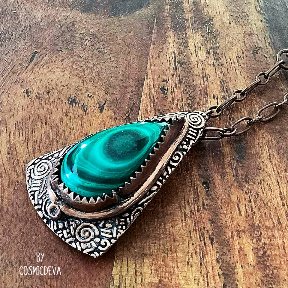 Wrap yourself in the irresistible beauty of nature with our Malachite Pendant Necklace. Handcrafted from pure copper and showcasing a stunning malachite gemstone cabochon, this gorgeous necklace is sure to be a conversation starter. Accented with malachite, volcanic rock, and copper beads- CosmicDeva