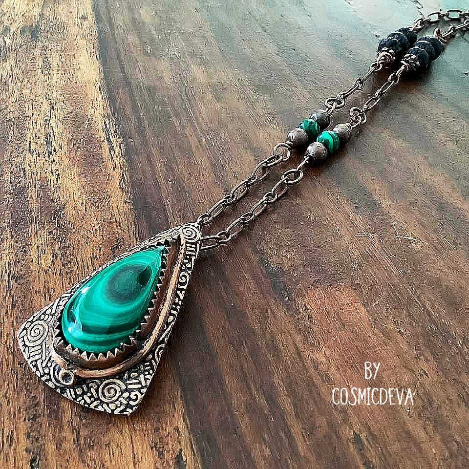 Wrap yourself in the irresistible beauty of nature with our Malachite Pendant Necklace. Handcrafted from pure copper and showcasing a stunning malachite gemstone cabochon, this gorgeous necklace is sure to be a conversation starter. Accented with malachite, volcanic rock, and copper beads. - CosmicDeva