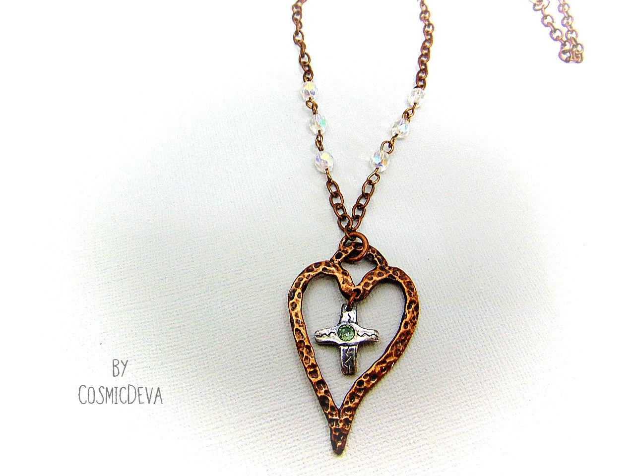 For The Love Of God - Express your faith in style and show your love for God with this beautiful handmade copper heart and sterling silver cross necklace, featuring an exquisite light blue topaz in the center. The deep warm finish and accentual aura white facetted Czech glass beads add a charming touch to your most special occasions.