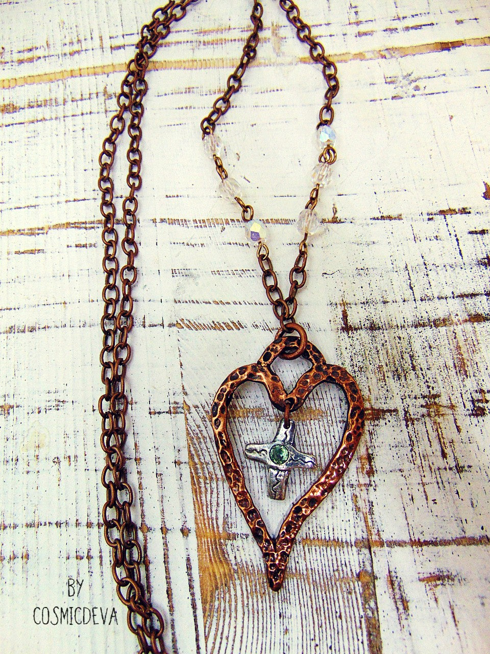 For The Love Of God - Express your faith in style and show your love for God with this beautiful handmade copper heart and sterling silver cross necklace, featuring an exquisite light blue topaz in the center. The deep warm finish and accentual aura white facetted Czech glass beads add a charming touch to your most special occasions.