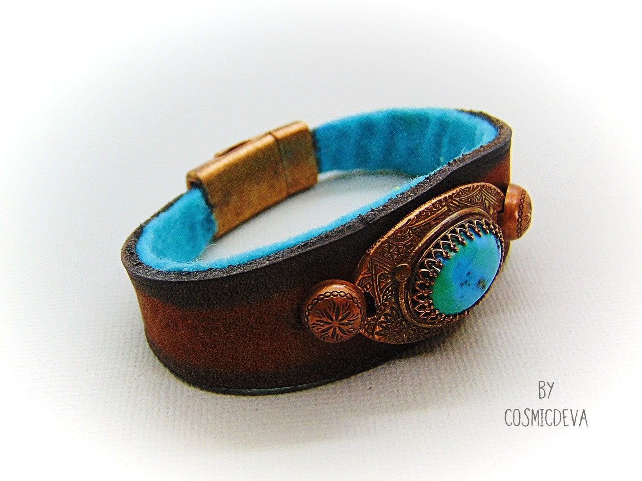 Beautiful one of a kind handcrafted southwestern leather bracelet made of earthy mid-western style brown dyed veg tan leather. The focal point is a natural stabilized Tibet turquoise with a bezel setting in solid copper.