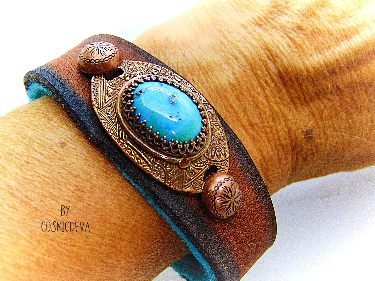 Beautiful one of a kind handcrafted southwestern leather bracelet made of earthy mid-western style brown dyed veg tan leather. The focal point is a natural stabilized Tibet turquoise with a bezel setting in solid copper.