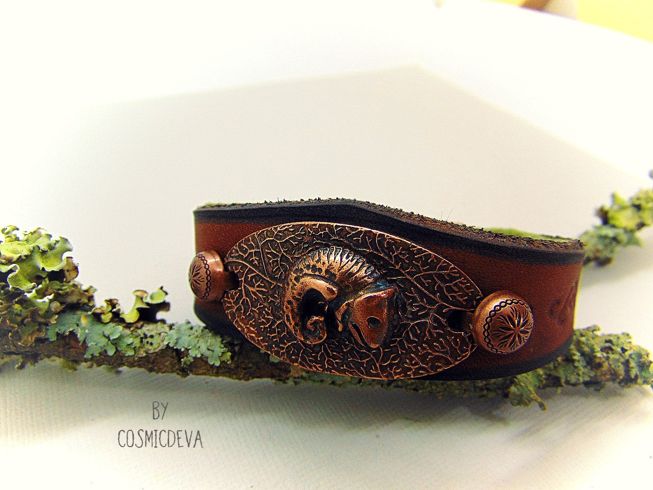 Unique handcrafted leather bracelet made of earthy brown dyed veg tan leather. The focal point is a hand sculptured solid copper chameleon on a textured solid copper base. The inside of the leather bracelet is lined with olive green felt for your comfort.