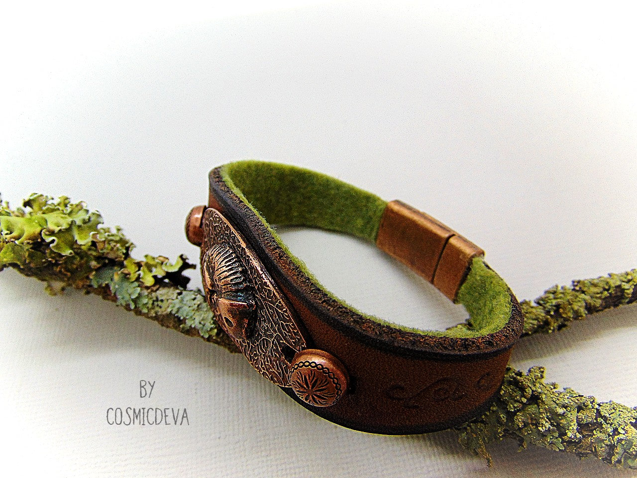 Unique handcrafted leather bracelet made of earthy brown dyed veg tan leather. The focal point is a hand sculptured solid copper chameleon on a textured solid copper base. The inside of the leather bracelet is lined with olive green felt for your comfort.