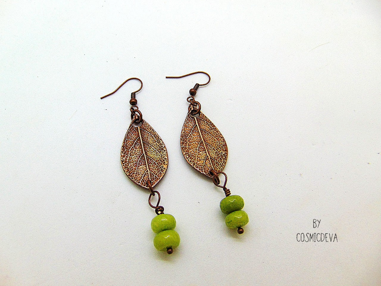 Lovely uniquely handcrafted sage leaf copper earrings featuring apple green dyed jade stone gemstone beads. These botanical copper earrings are made of high-quality materials with attention to details. The metal components were made by me: leaf earrings were crafted from solid copper, uniquely textured and carved and polished to bring out the highlights.  cosmicdeva