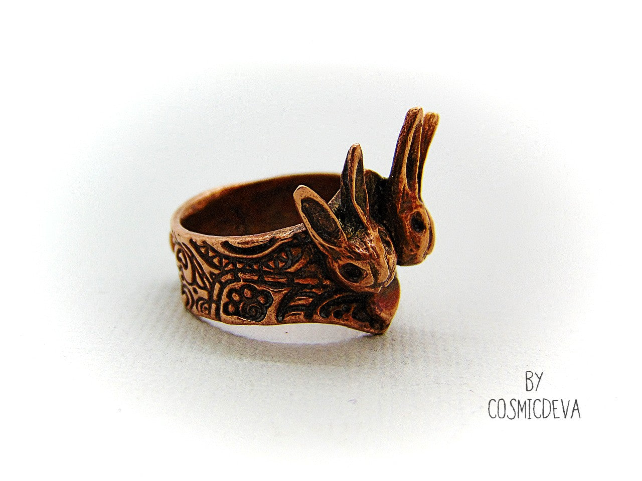 Love bunnies? Show your devotion with this gorgeous Copper Bunny Love Ring! Crafted by hand, it features two snuggled bunny heads with a heart in the middle, plus a textured shank and a heart on the back. One-of-a-kind and unique, this US Size 7.5 Ring is perfect for expressing your style and your bunny appreciation! cosmicdeva