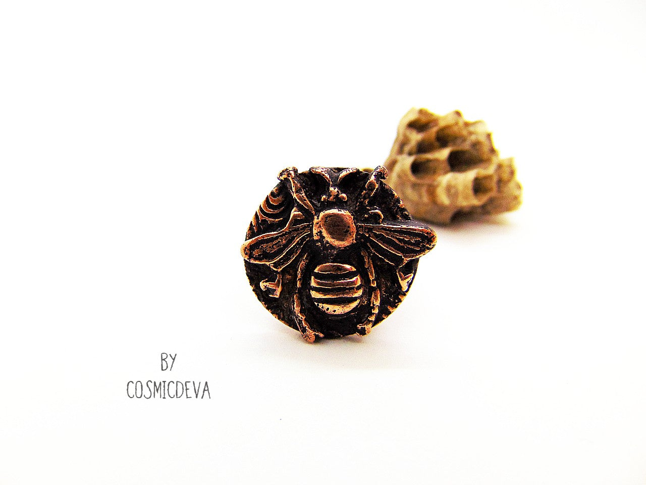 Handmade queen bee goddess, honey bee ring made of solid copper. The ring shank has a beautiful texture and has the cosmicdeva logo inside.Handmade queen bee goddess, honey bee ring made of solid copper. The ring shank has a beautiful texture and has the cosmicdeva logo inside.