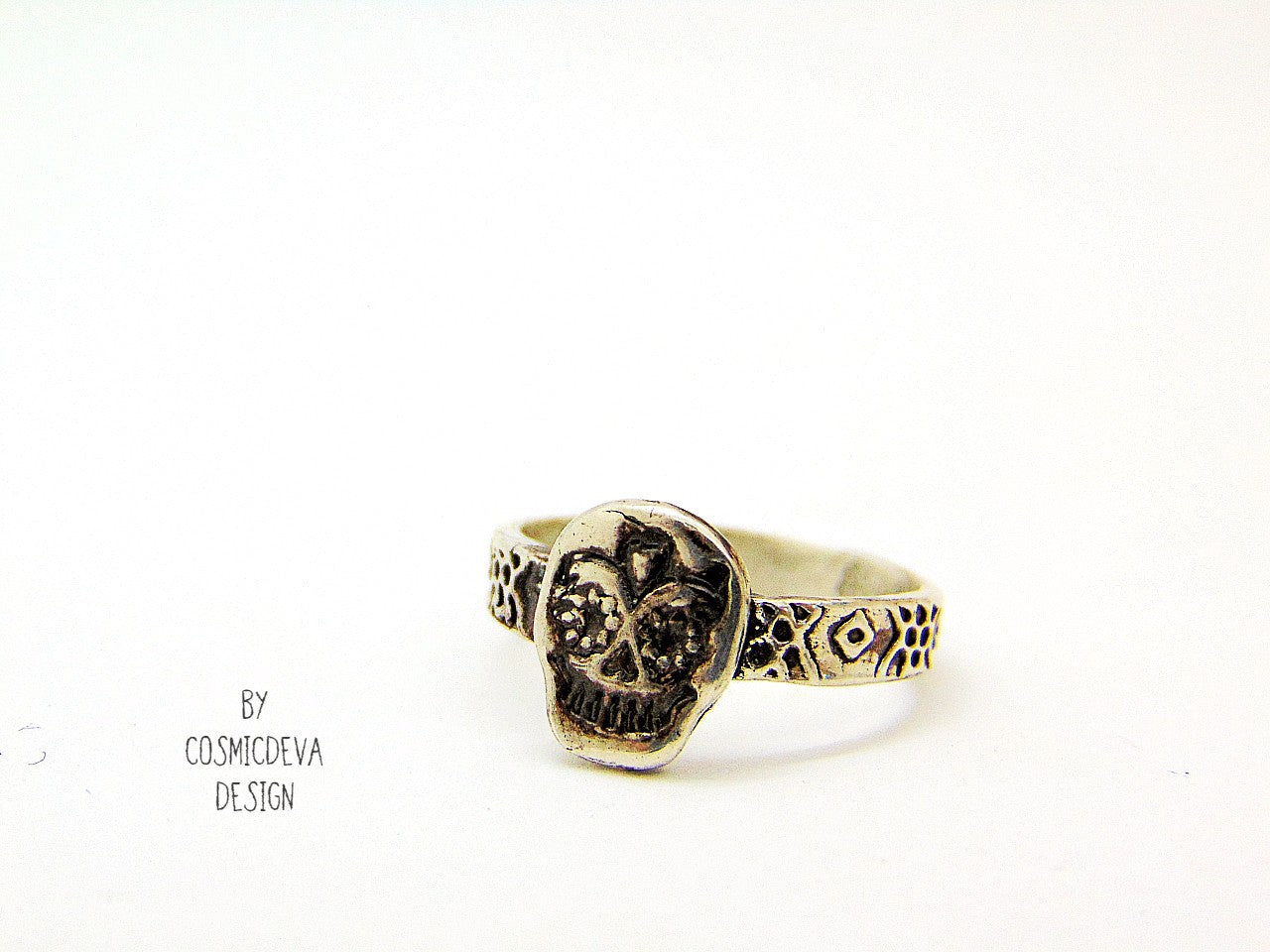 Handmade cute dainty sugar scull sterling silver ring. The inside of the ring has a polish with a few small irregularities from the forming process. The sterling silver sugar scull ring has been oxidized. The sugar skull is the predominant symbol of the "Day of the Dead", or Día de Los Muertos in Mexican culture. 