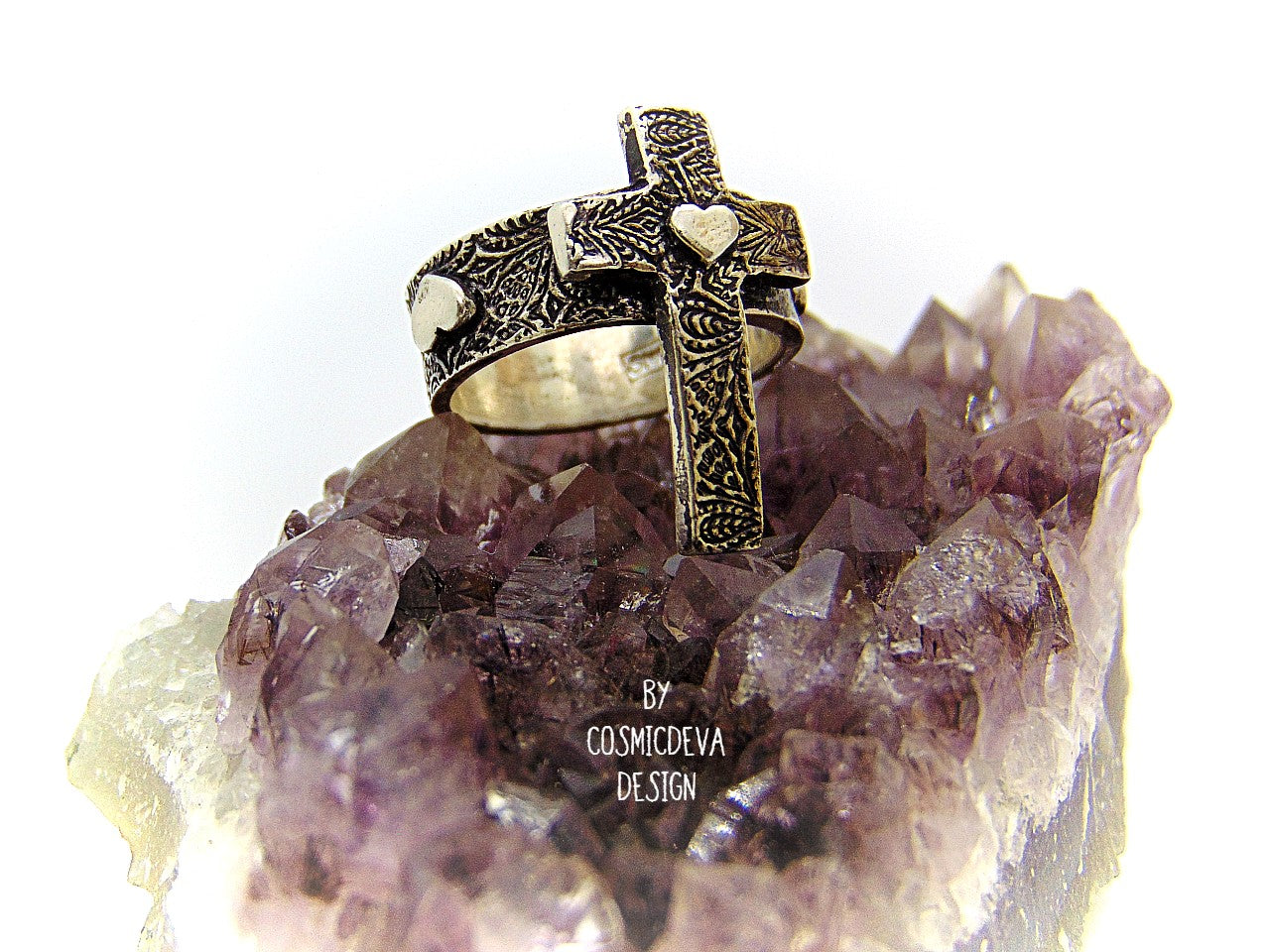 Completely handcrafted solid sterling silver cross ring. The surface of the ring features a rich oxidized textured cross with a heart in the center of the cross. The heart symbol in the center of the cross and on the sides of the ring shank is a reminder that Christ as a foundation is built on love – all the love we have for others should be unconditional in the same way he loves us. Love each other as I have loved you – John 15:12.
