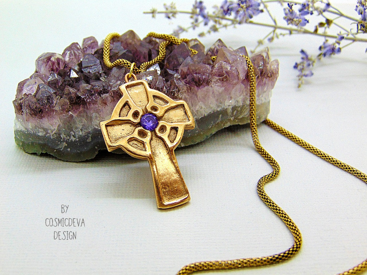 This handmade rustic Celtic Irish Cross pendant is made of solid gold bronze with a purple Amethyst in the center. The circle in the center represents the sun, an important item of worship in druid religion.