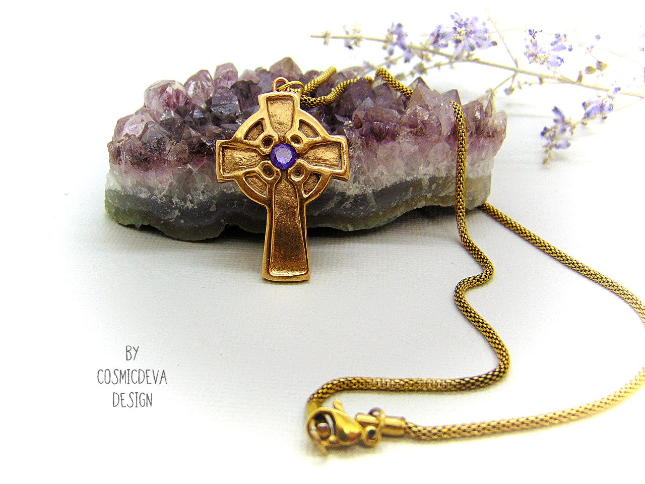 This handmade rustic Celtic Irish Cross pendant is made of solid gold bronze with a purple Amethyst in the center. The circle in the center represents the sun, an important item of worship in druid religion.