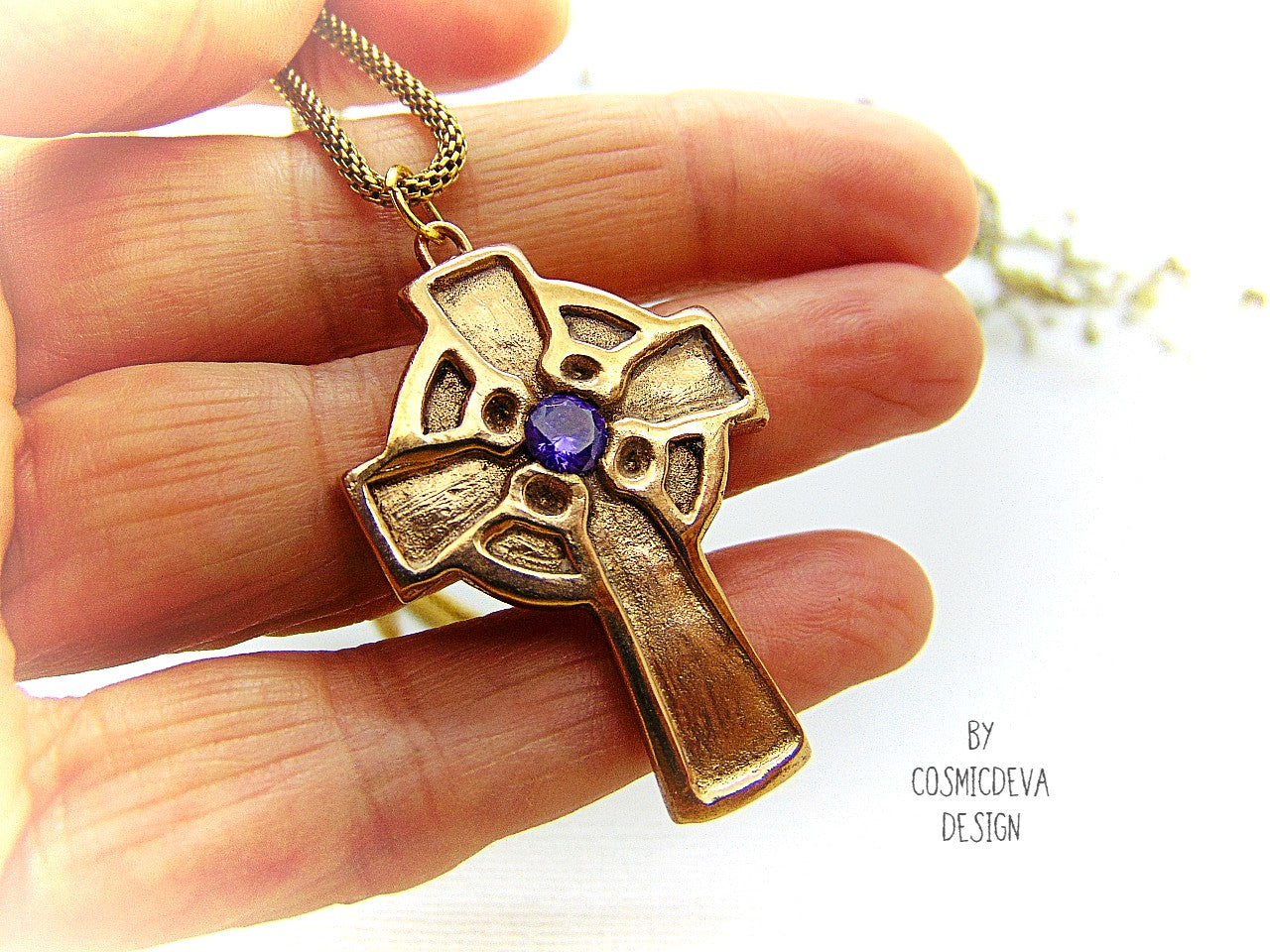 This handmade rustic Celtic Irish Cross pendant is made of solid gold bronze with a purple Amethyst in the center. The circle in the center represents the sun, an important item of worship in druid religion.