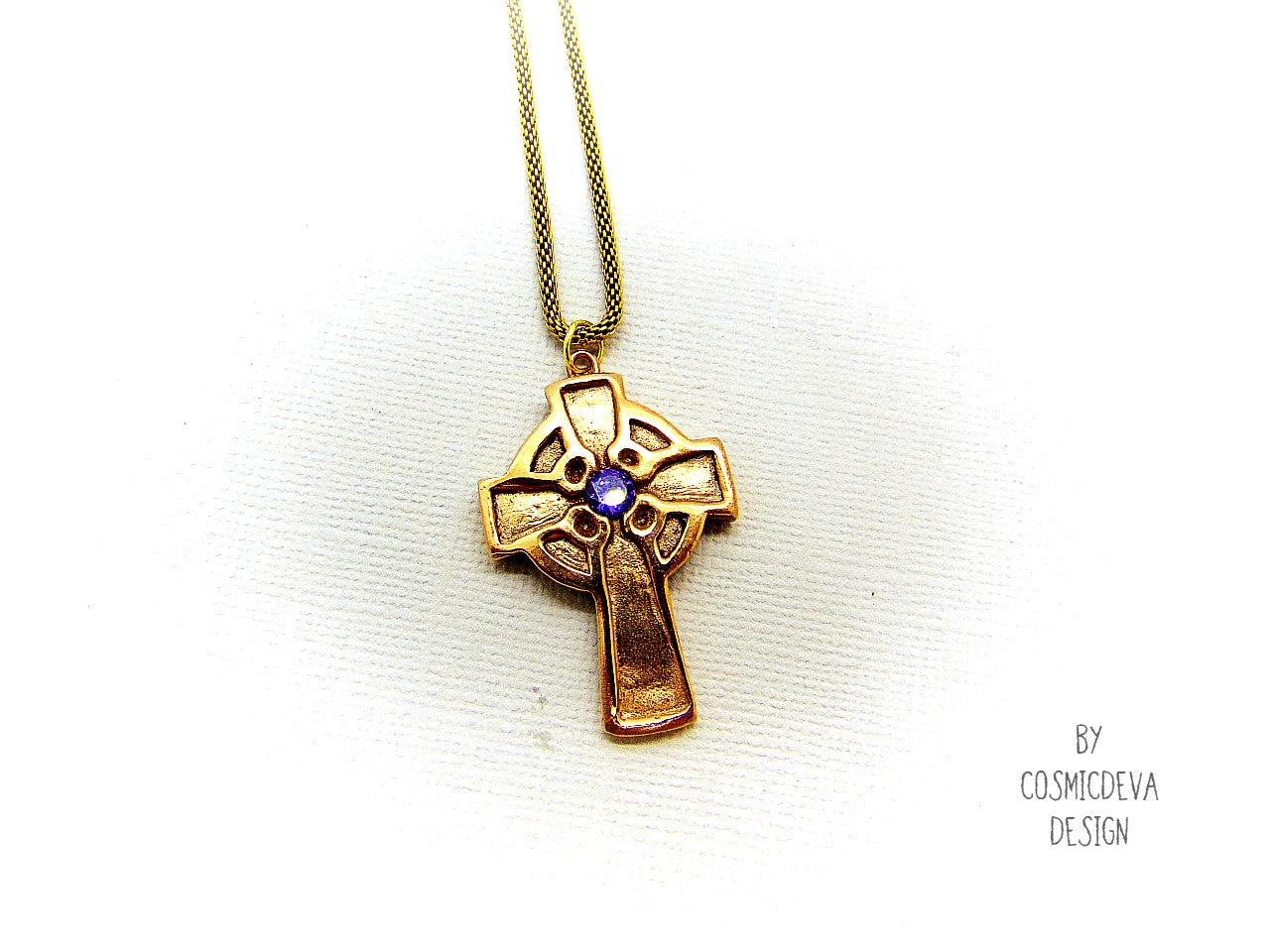 This handmade rustic Celtic Irish Cross pendant is made of solid gold bronze with a purple Amethyst in the center. The circle in the center represents the sun, an important item of worship in druid religion.