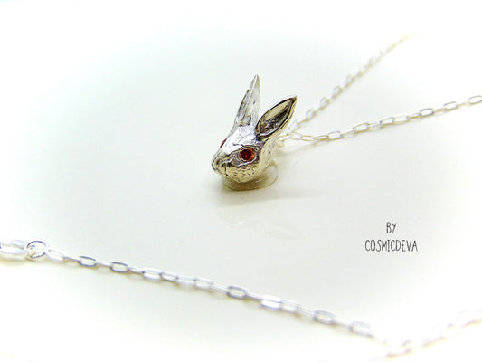 Handmade dainty small little rabbit 🐰 made of solid sterling silver with tiny faceted lab created fire opal eyes. Lab created stones are chemically, physically and optically identical to those mined underground. This cute little bunny dangles from a delicate 18 inch solid .925 sterling silver flat cable 1.4mm chain necklace.