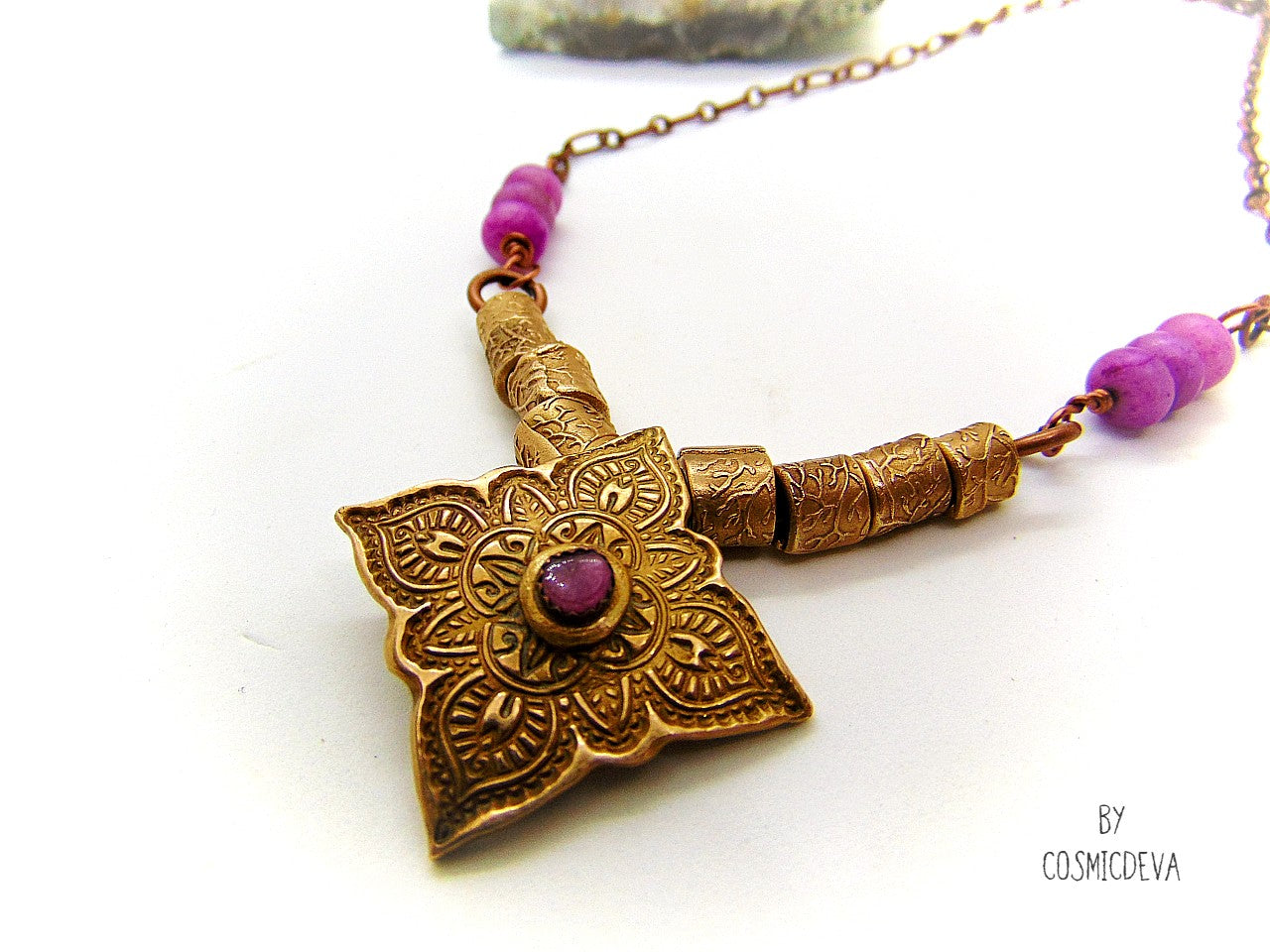Enliven your wardrobe with this stunning Pink Tourmaline Mandala Mehndi Gold Bronze Necklace! Crafted with a unique hand formed bronze mandala pendant, pink tourmaline gemstone, and lovely pink jasper rondelle beads, this piece is perfect for yoga meditations or everyday wear. Adorn yourself with inspiring beauty! 