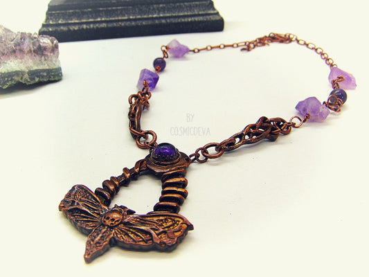 Handcrafted detailed death head hawk Moth (Acherontia) made of solid copper with a natural amethyst cabochon setting. The pendant is the focal point of a chain necklace with drilled natural raw amethyst gemstones, natural amethyst round beads and two completely handcrafted copper Celtic knot design findings.