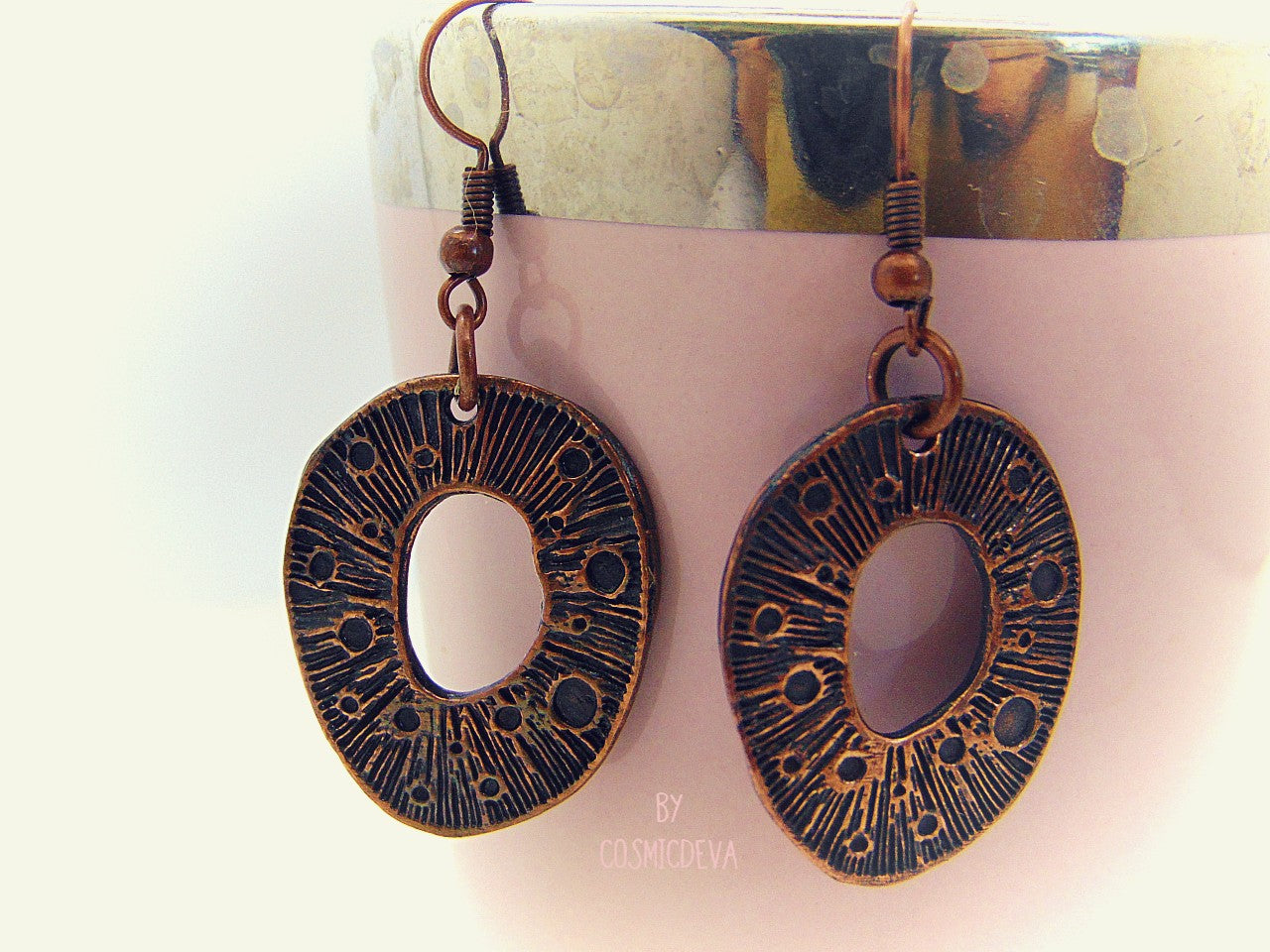 These organic copper dangle earrings are the perfect pick for any season. Handcrafted in the studio, they feature a unique organic texture and warm patinated copper color that can't be found anywhere else. Lightweight and comfortable to wear, no two pairs are ever alike!