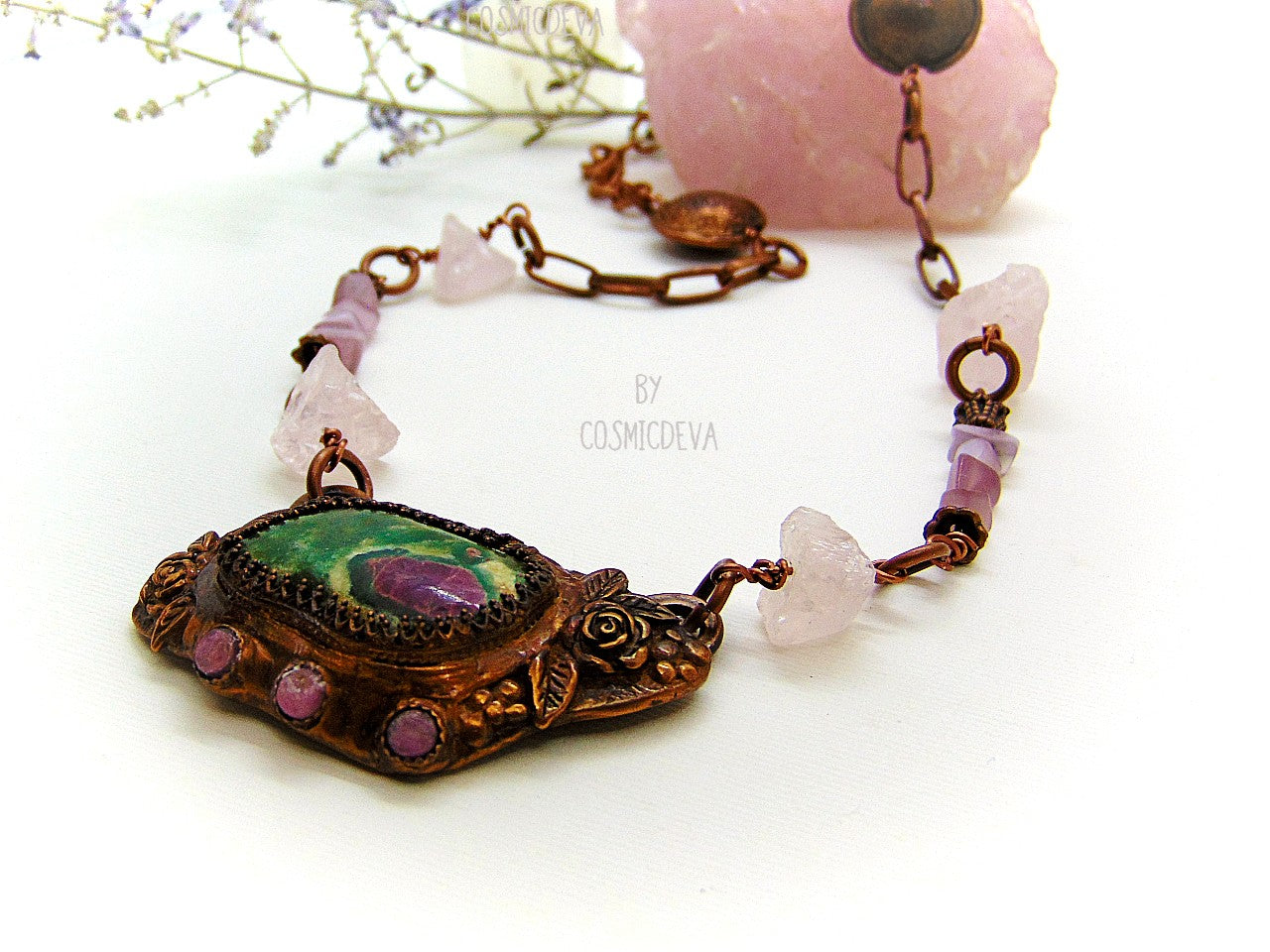 One of a kind handmade necklace with a hand sculptured solid copper pendant featuring a beautiful ruby in fuchsite gemstone cabochon in a bezel setting, surrounded with roses and natural raw pink tourmaline gemstones. This ruby in fuchsite statement necklace pendant suspends from a copper chain with accentual raw rose quartz crystal gemstones and handcrafted copper lentil beads.