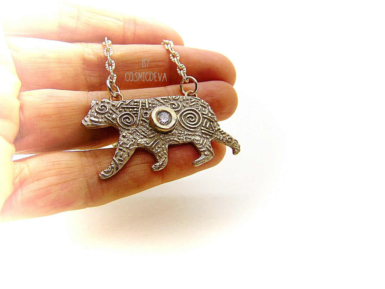 Inspire yourself to be strong and graceful like a polar bear with this handcrafted Silver Bear Spirit Animal Pendant Bronze Necklace. Crafted with a kiln fired silver bronze bear, accented with a diamond cut cubic zirconia gemstone, this pendant suspends from an 18-20 inch long chain. Wear this powerful piece and feel the power of the wild!