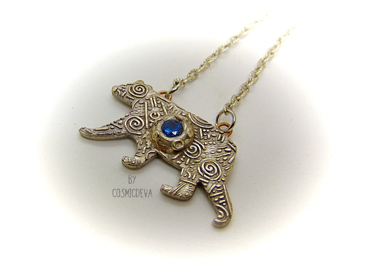 Bring the strength of your spirit animal home with this beautiful handcrafted polar bear pendant! Featuring a 5mm lab-grown blue spinel gemstone and a bronze finish, this necklace is strong and stylish. With a durable adjustable 18-20 inch chain, you can take the comforting power of your spirit animal with you wherever you go!