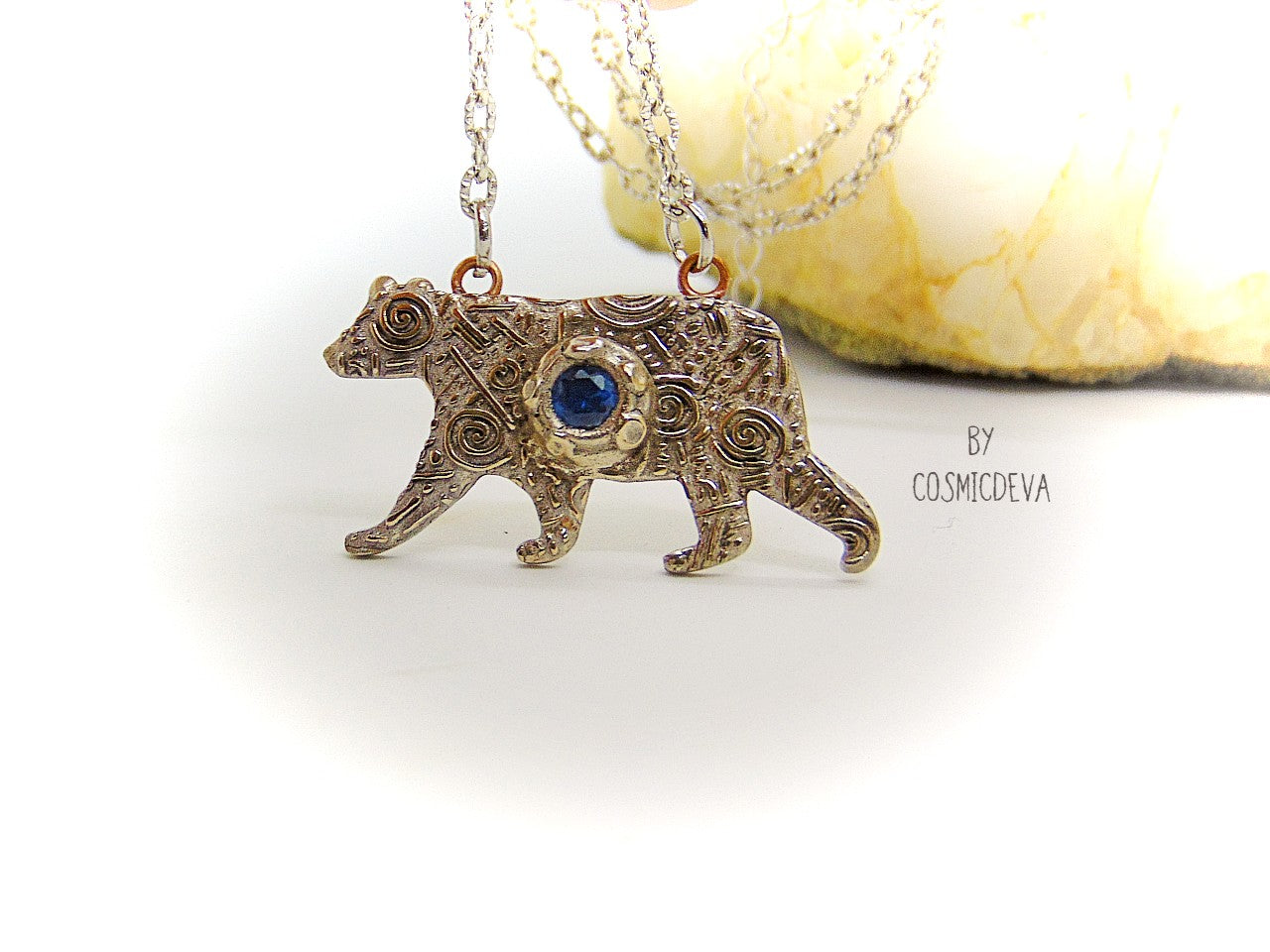 Bring the strength of your spirit animal home with this beautiful handcrafted polar bear pendant! Featuring a 5mm lab-grown blue spinel gemstone and a bronze finish, this necklace is strong and stylish. With a durable adjustable 18-20 inch chain, you can take the comforting power of your spirit animal with you wherever you go!