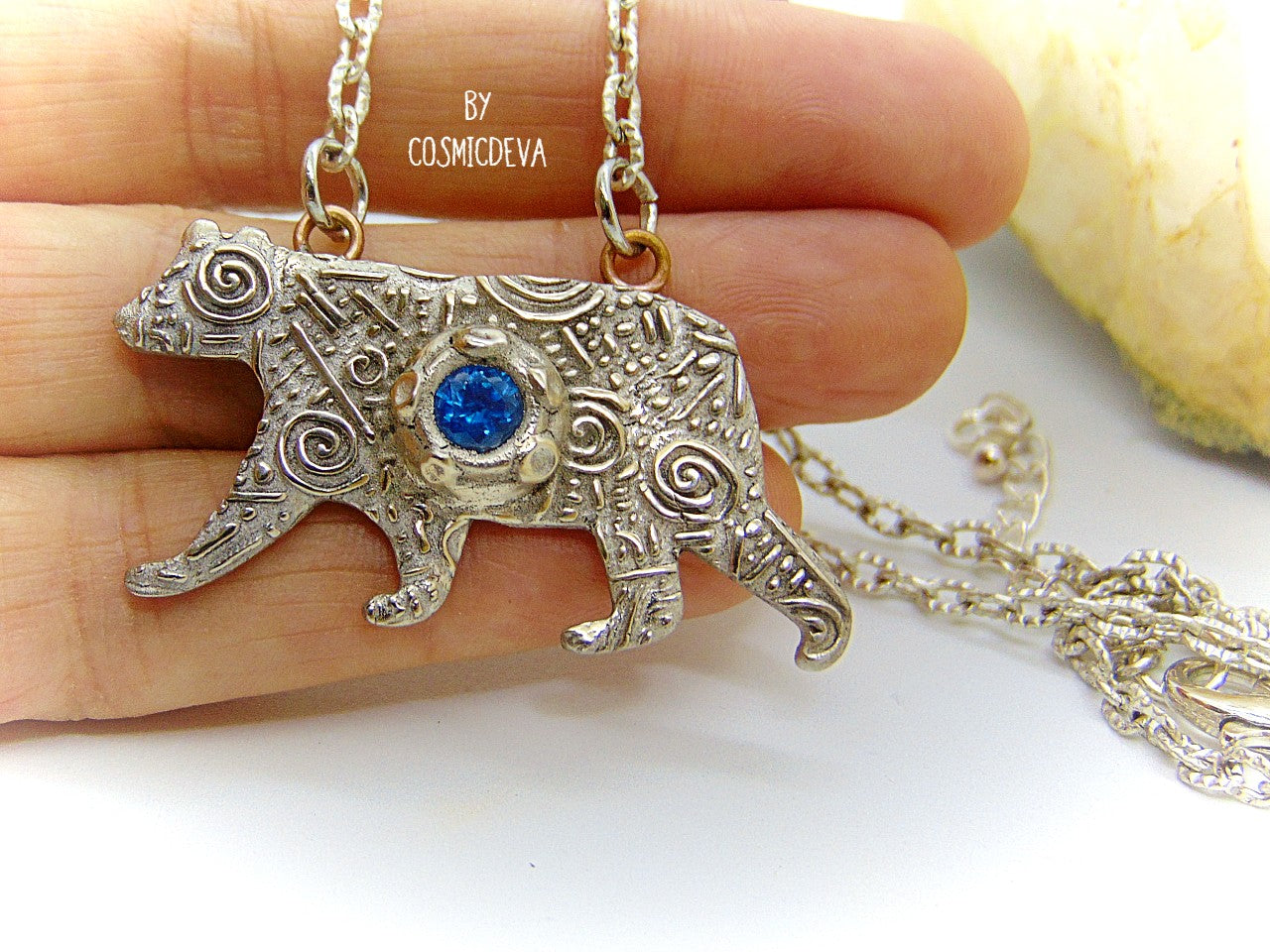 Bring the strength of your spirit animal home with this beautiful handcrafted polar bear pendant! Featuring a 5mm lab-grown blue spinel gemstone and a bronze finish, this necklace is strong and stylish. With a durable adjustable 18-20 inch chain, you can take the comforting power of your spirit animal with you wherever you go!