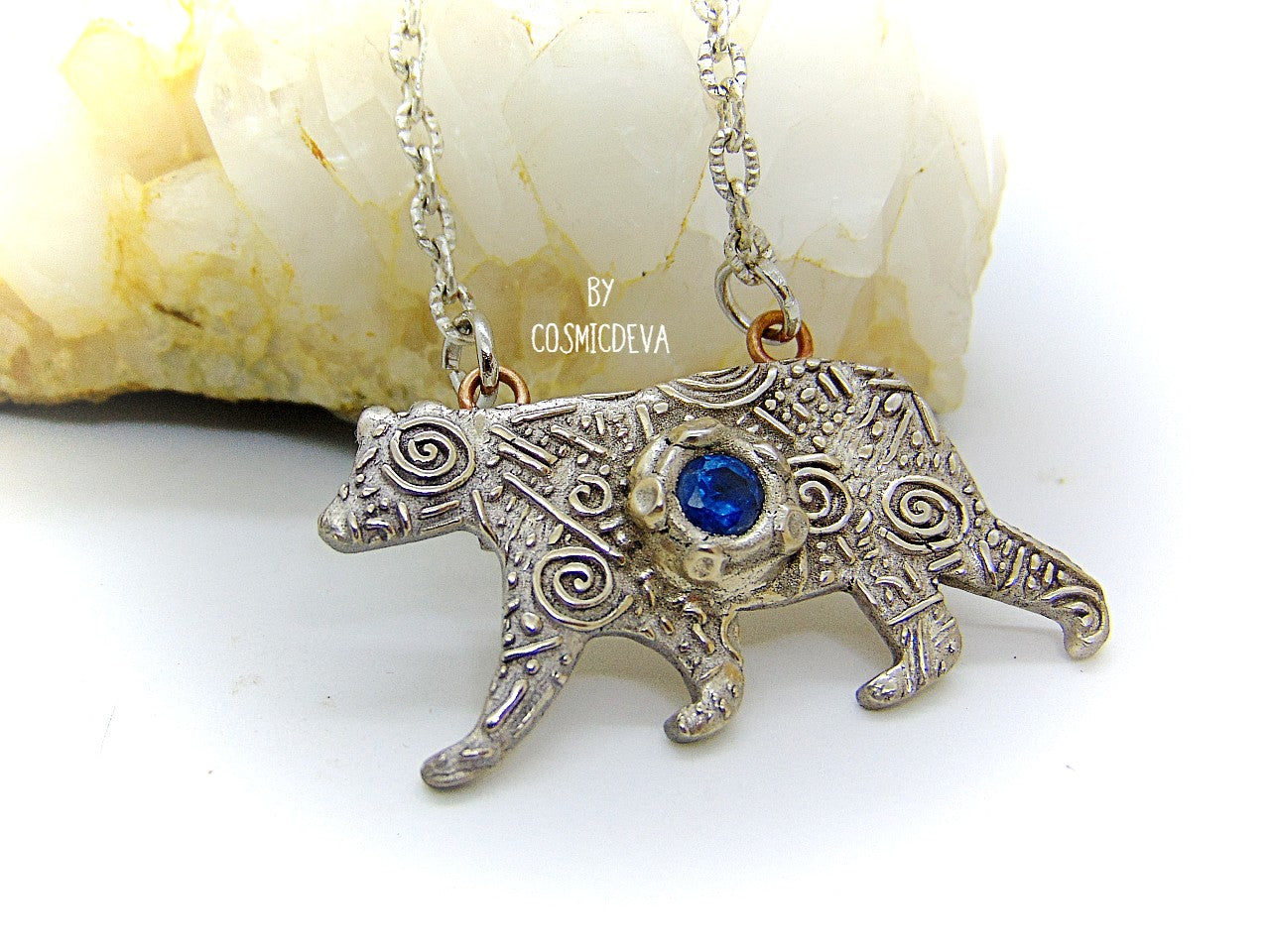Bring the strength of your spirit animal home with this beautiful handcrafted polar bear pendant! Featuring a 5mm lab-grown blue spinel gemstone and a bronze finish, this necklace is strong and stylish. With a durable adjustable 18-20 inch chain, you can take the comforting power of your spirit animal with you wherever you go!