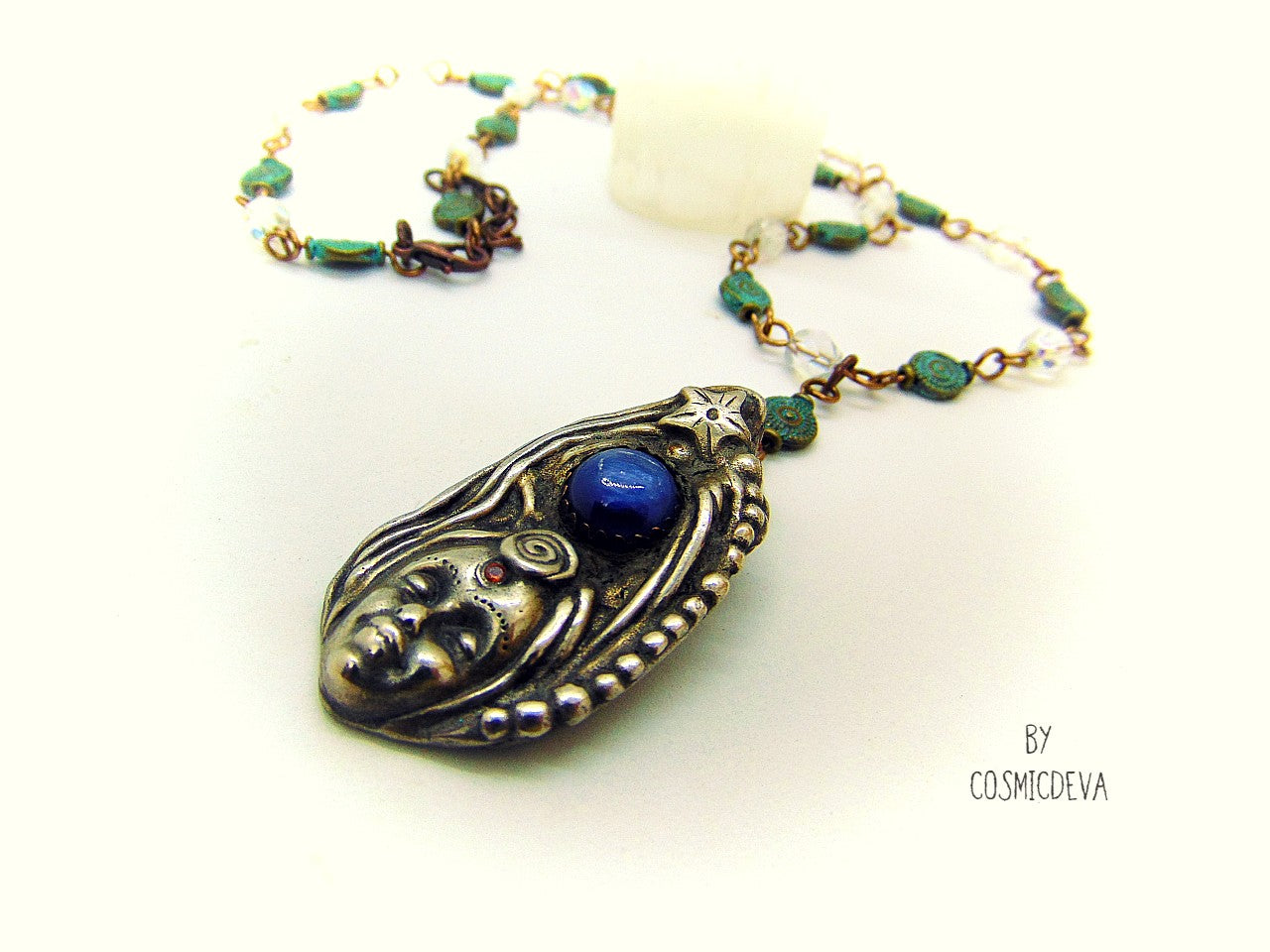 Be inspired with this unique, handmade Goddess Silver Bronze Necklace with a Blue Kyanite gemstone. Its one-of-a-kind design will bring beauty and enchantment to your life! A tiny fire opal adorns the goddess' third eye for an added spark of color and power. Crafted with love, it will be your cherished companion for many years.