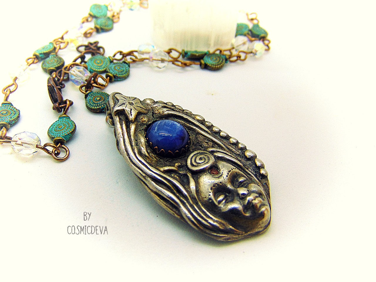 Be inspired with this unique, handmade Goddess Silver Bronze Necklace with a Blue Kyanite gemstone. Its one-of-a-kind design will bring beauty and enchantment to your life! A tiny fire opal adorns the goddess' third eye for an added spark of color and power. Crafted with love, it will be your cherished companion for many years.