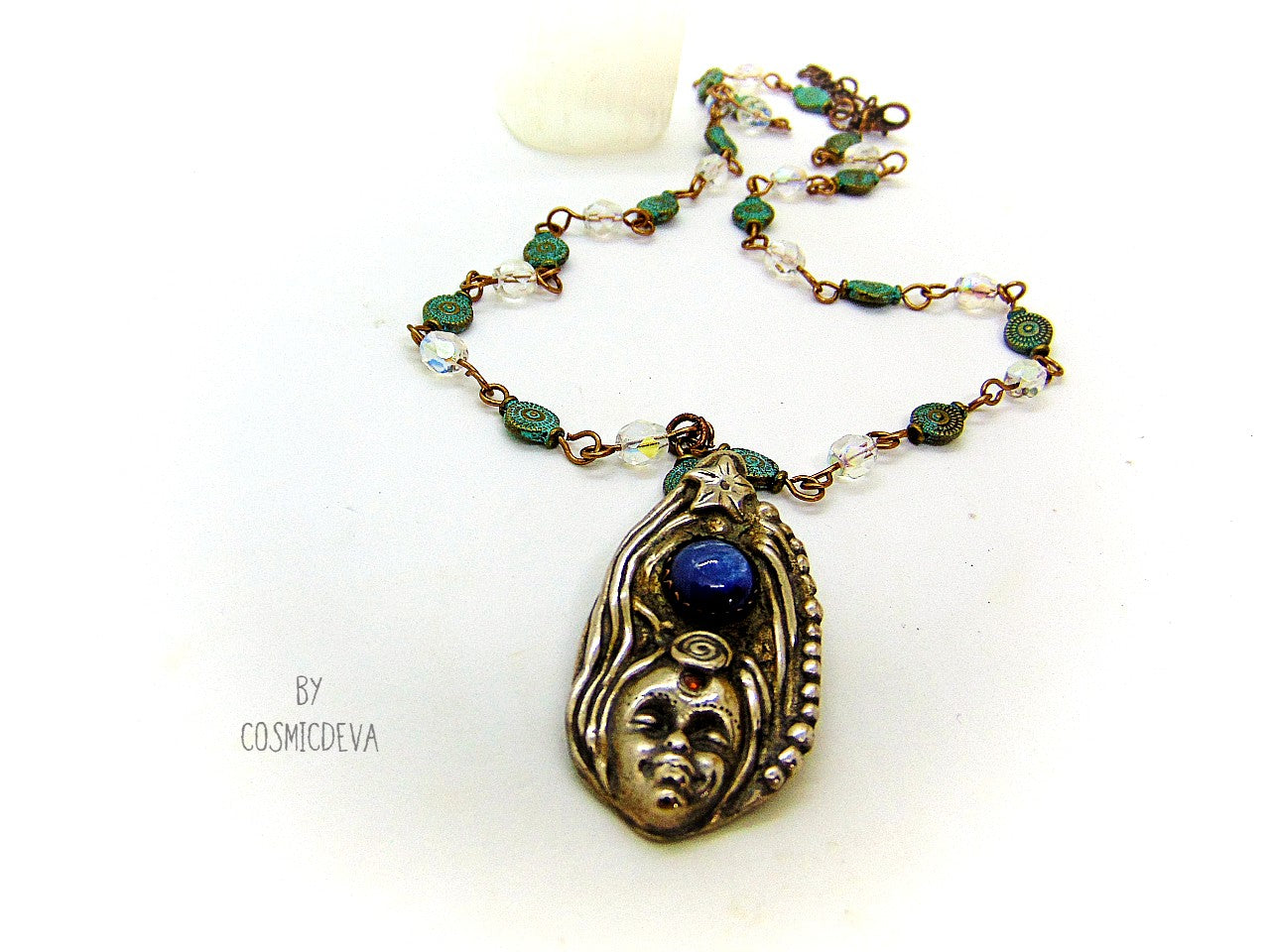Be inspired with this unique, handmade Goddess Silver Bronze Necklace with a Blue Kyanite gemstone. Its one-of-a-kind design will bring beauty and enchantment to your life! A tiny fire opal adorns the goddess' third eye for an added spark of color and power. Crafted with love, it will be your cherished companion for many years.