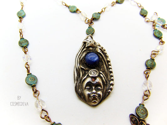 Be inspired with this unique, handmade Goddess Silver Bronze Necklace with a Blue Kyanite gemstone. Its one-of-a-kind design will bring beauty and enchantment to your life! A tiny fire opal adorns the goddess' third eye for an added spark of color and power. Crafted with love, it will be your cherished companion for many years.