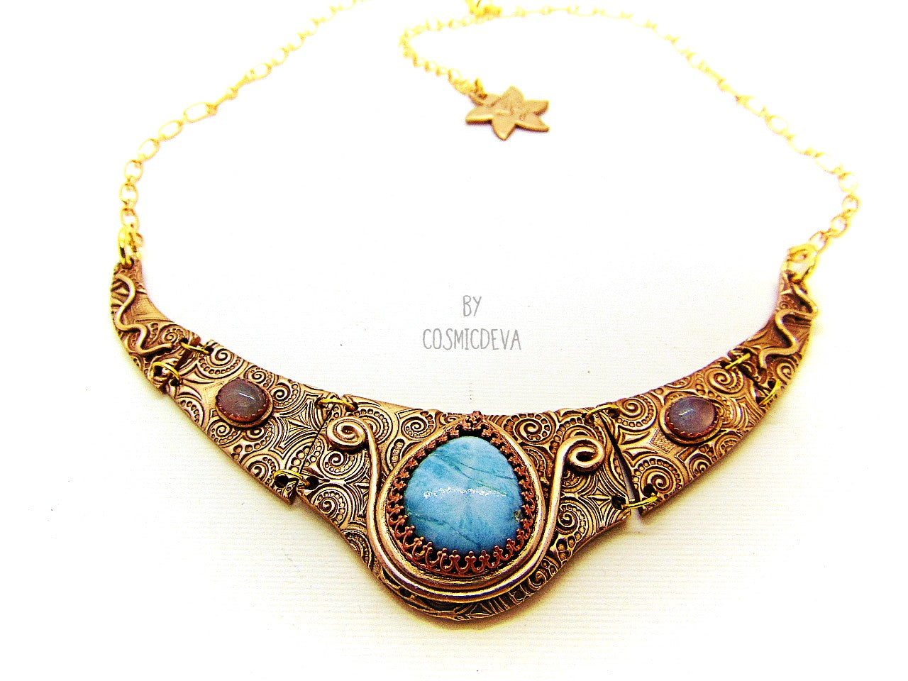 Distinguish yourself with this stunning Ancient Style Choker Collar With Larimar Gold Bronze Necklace. Hand-formed with solid gold bronze, it exudes elegance with the aquamarine and larimar gemstones embedded in its center. Feel luxurious and be the envy of all! A unique adornment that will adore to wear in all occasions.