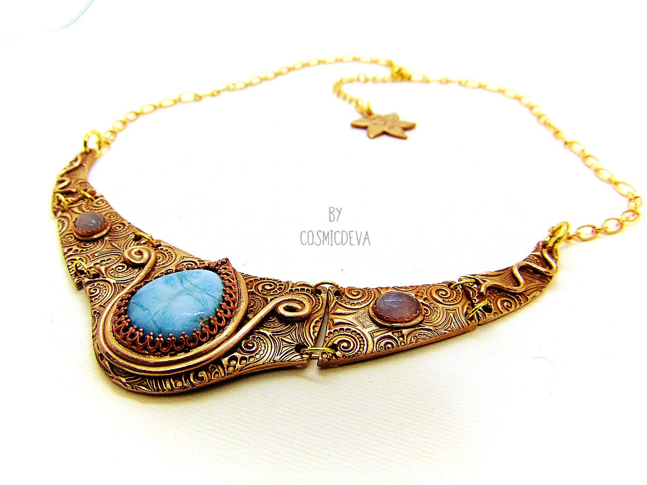 Distinguish yourself with this stunning Ancient Style Choker Collar With Larimar Gold Bronze Necklace. Hand-formed with solid gold bronze, it exudes elegance with the aquamarine and larimar gemstones embedded in its center. Feel luxurious and be the envy of all! A unique adornment that will adore to wear in all occasions.