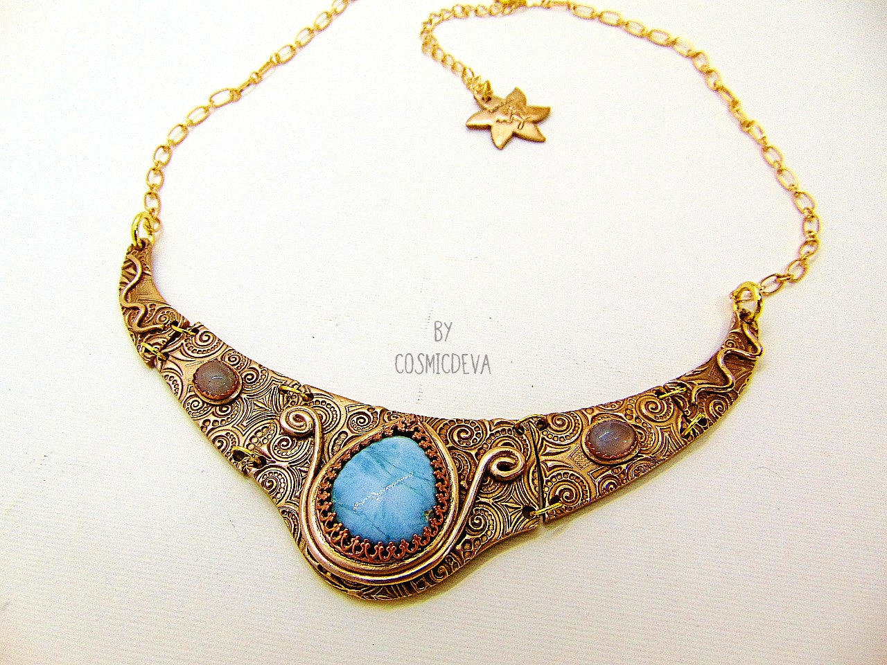 This lovely collar is completely hand formed with solid gold bronze. The center of this Mycenean inspired choker necklace is adorned with a beautiful aqua blue larimar gemstone and two aquamarine gemstones. A unique adornment that will adore to wear in all occasions.