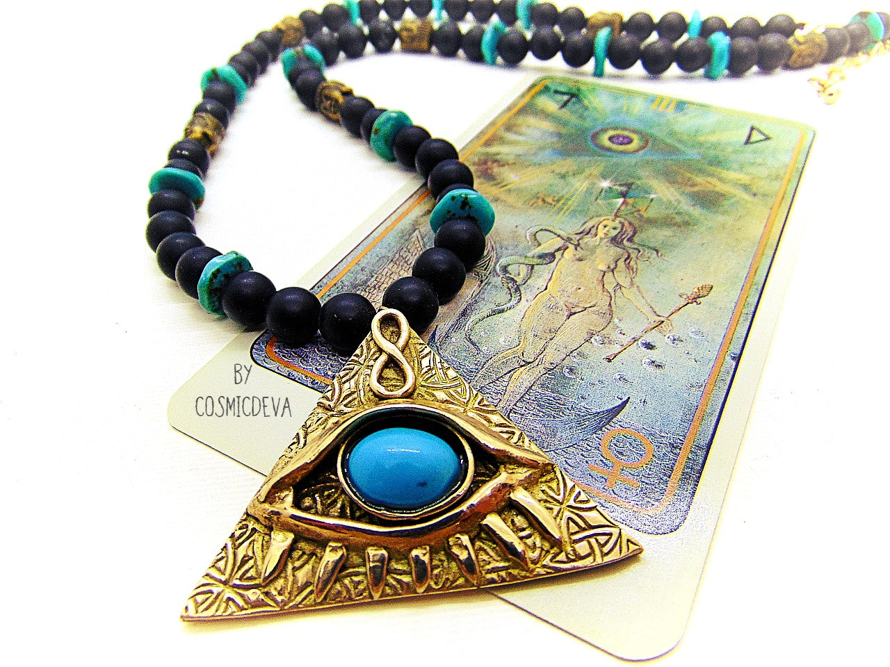 Adorn yourself with this mystical completely hand sculptured bronze All Seeing Eye necklace and protect your soul with its natural turquoise and black onyx gemstones. Feel the spiritual energy of its Infinity symbol and antique brass buddha head beads, inspiring knowledge and positivity. Experience the power of the eye each time you wear it!